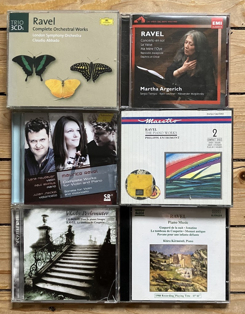 Six Ravel CDs on a wood floor