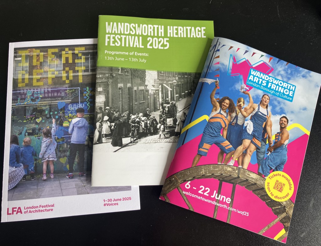Three brochures against a black background. The brochures are for London Festival of Architecture, Wandsworth Heritage Festival and Wandsworth Arts Fringe.