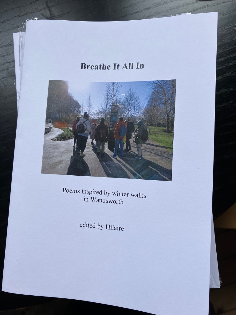 A copy of the booklet Breathe It All In against a black background